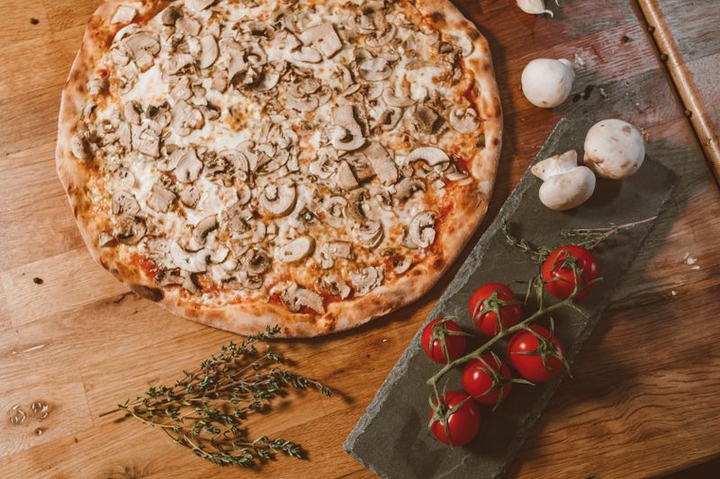 Punch pizza fresh artisan pizza out of the wood-fired oven